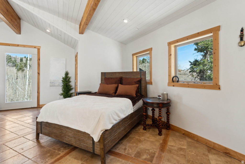 Vaulted ceiling with exposed wood beams and white planking