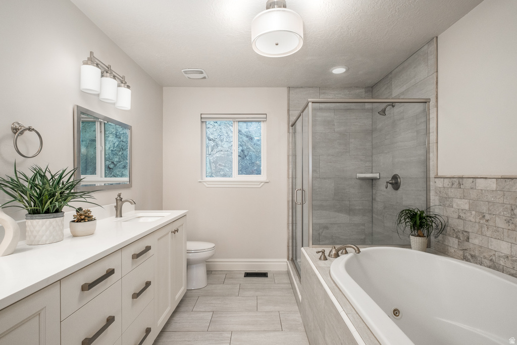 Contemporary bathroom featuring a white vanity with multiple drawers, a rectangular undermount sink, and a framed mirror