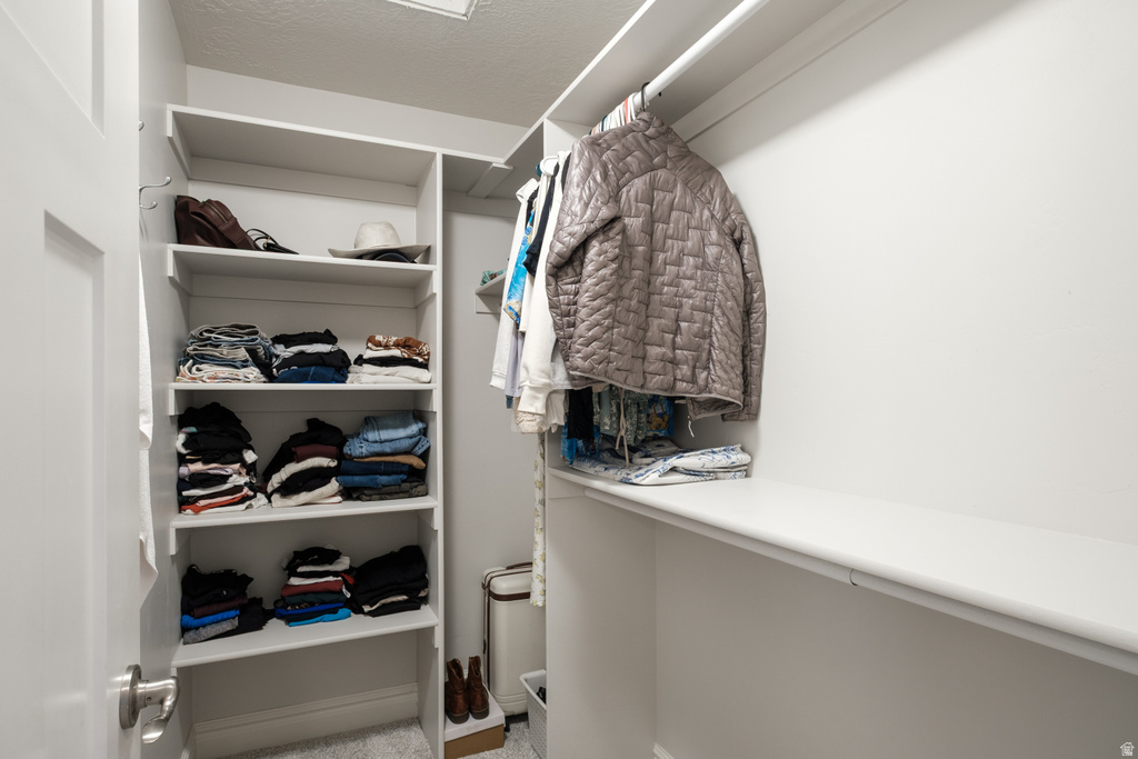 Custom closet system featuring built-in shelving, multiple hanging rods, and ample storage space