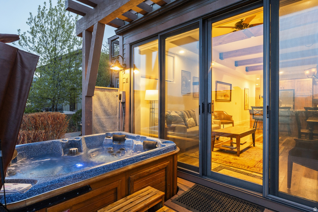 Outdoor spa with integrated lighting, wood-paneled exterior, and slatted wood-finish deck