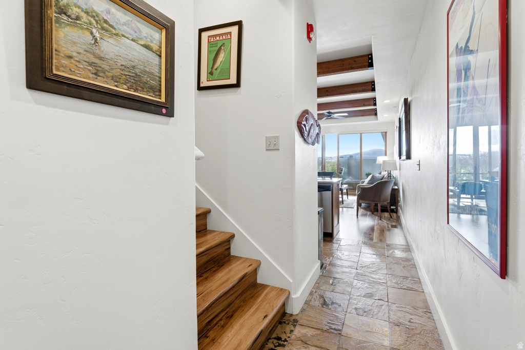 Entryway featuring natural wood-finish staircase and tile flooring