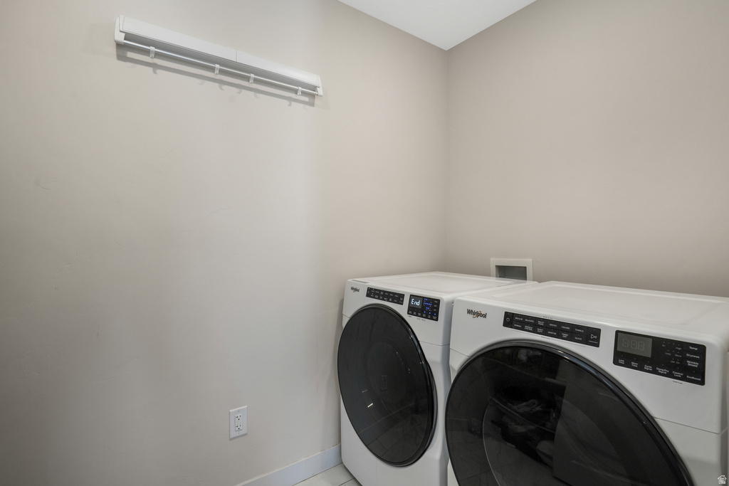 Laundry area featuring light-toned wall paint and white baseboards