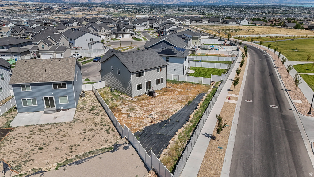 Gray two-story residence featuring a private backyard with partial fencing
