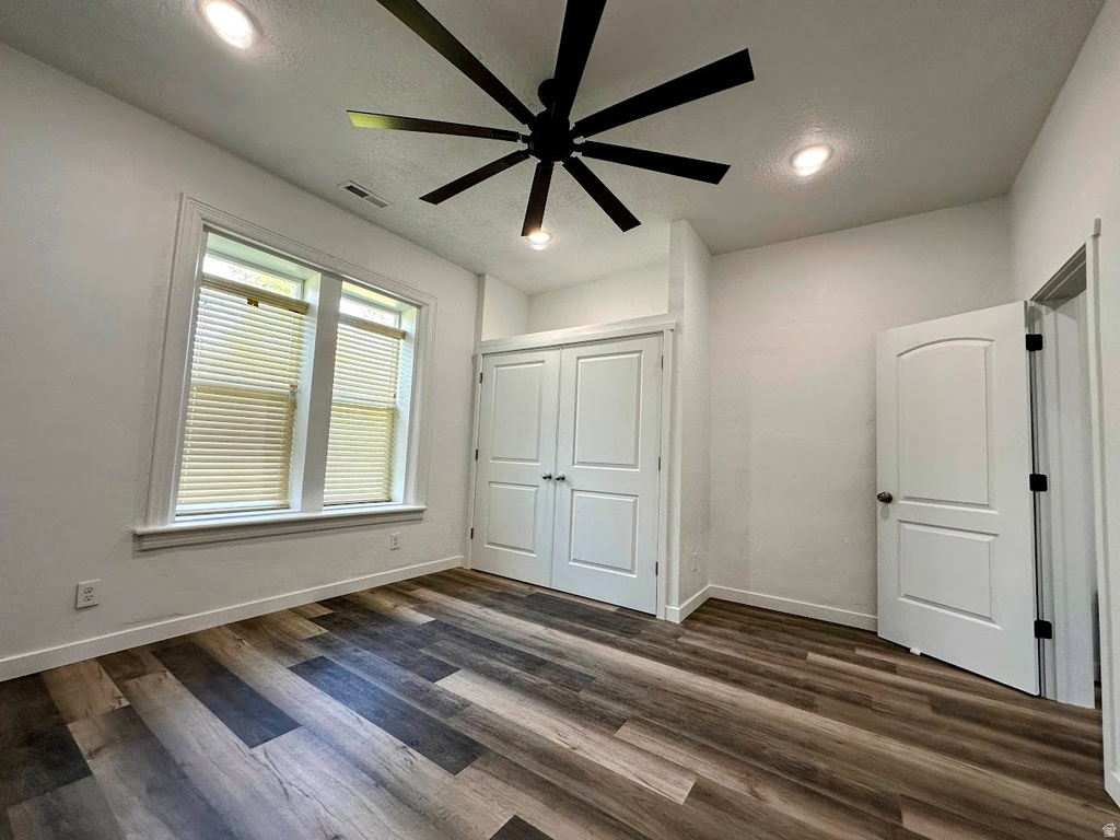 Room featuring wood-finish flooring, recessed lighting, and a contemporary ceiling fan