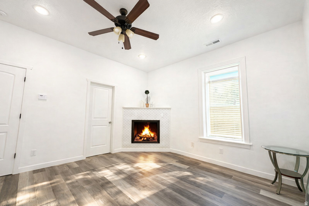 Living area featuring a corner fireplace with a white mosaic tile surround and mantel