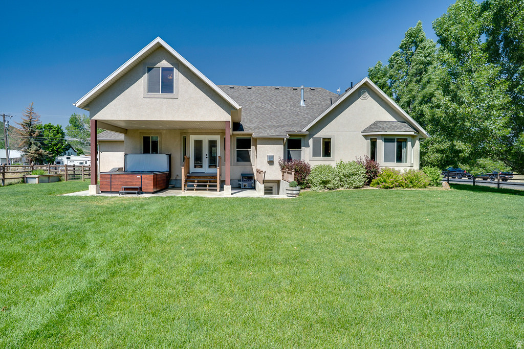 Expansive rear yard featuring a large green lawn