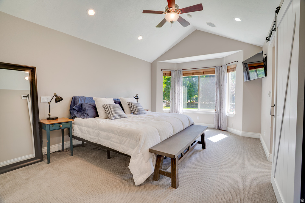 Bedroom featuring a vaulted ceiling with a ceiling fan, recessed lighting, and bay windows