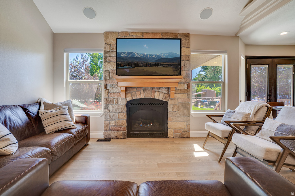 Stone-clad fireplace with wood mantel