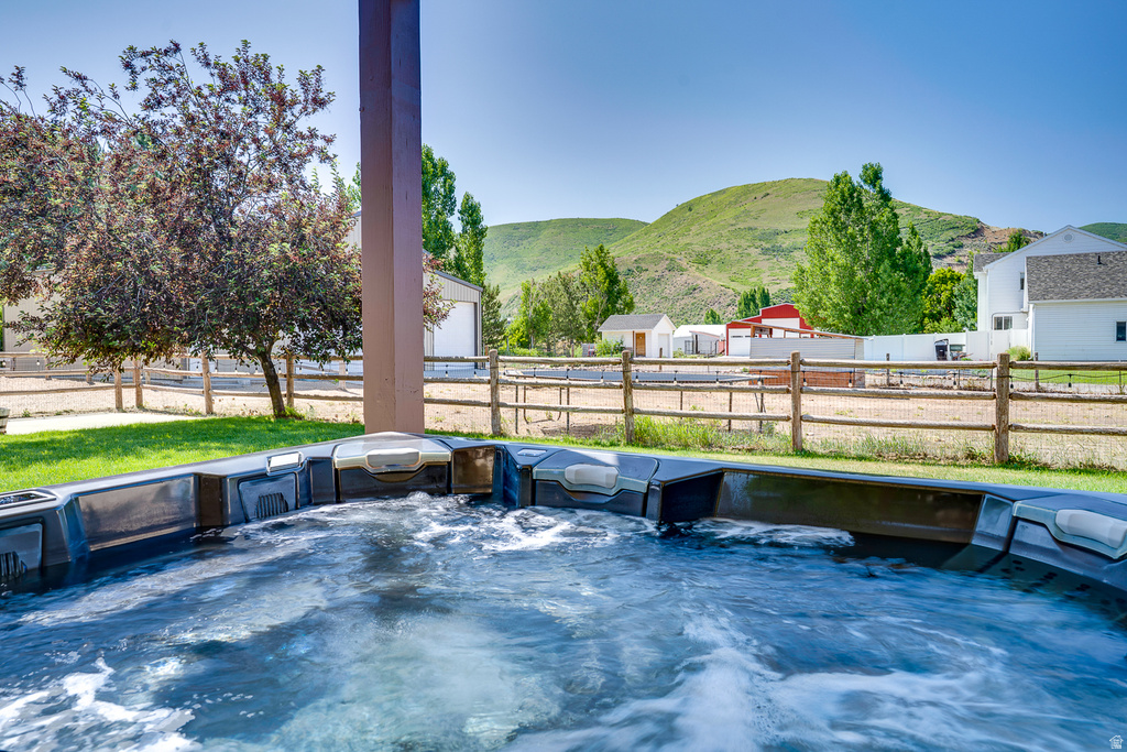Outdoor spa featuring a dark exterior finish and integrated seating