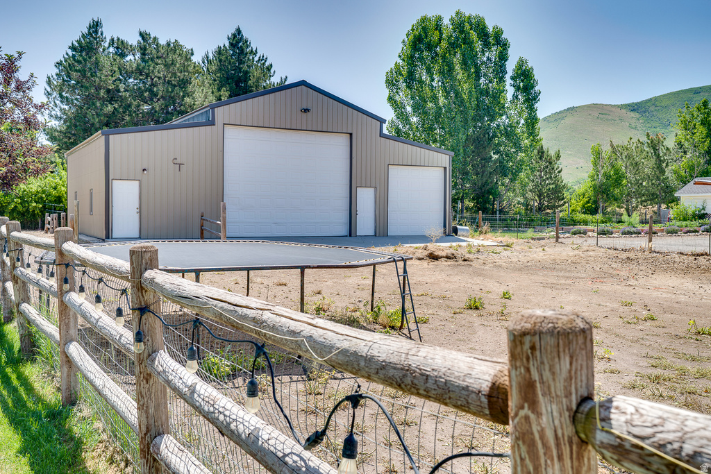 Expansive outbuilding with a large roll-up door and an additional entry door