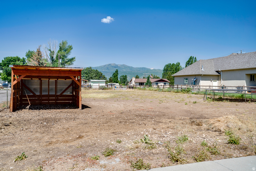 Expansive lot featuring a wooden run-in shed with a metal roof