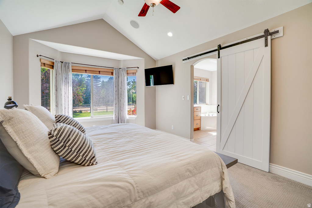 Room featuring a vaulted ceiling with recessed lighting, a ceiling fan, and a large bay window