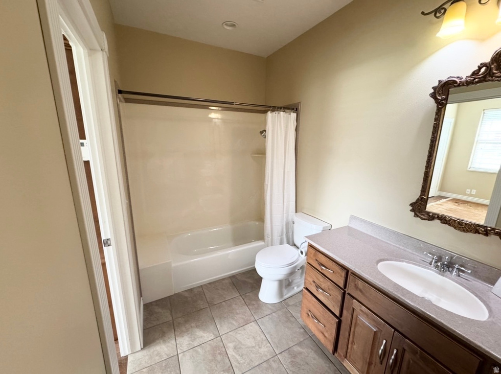 Bathroom featuring a single vanity with wood-finish cabinetry, a light-colored countertop, and a recessed sink