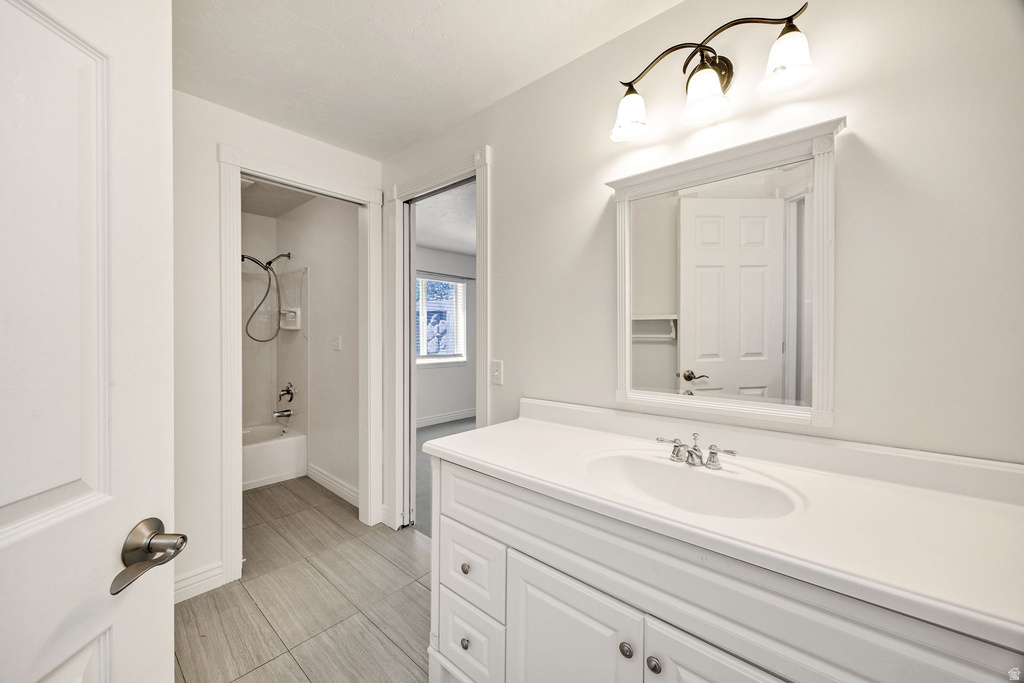 White vanity with integrated sink and chrome fixtures