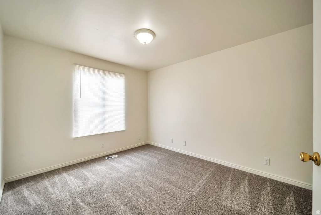 Room featuring neutral wall tones and textured carpeting