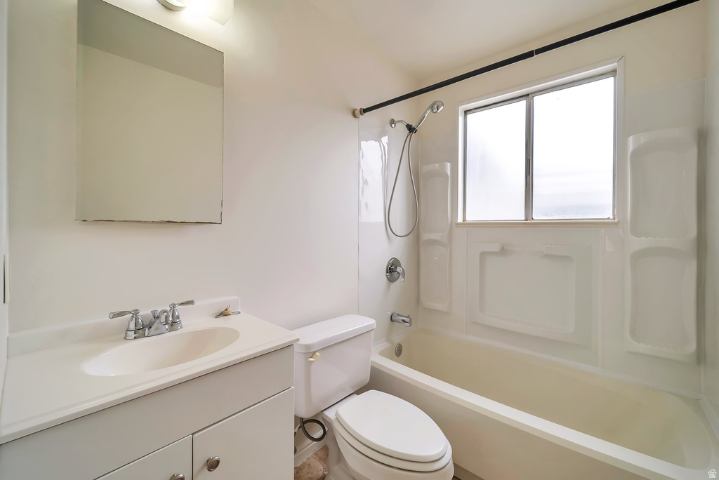 Bathroom featuring a built-in tub/shower combination with white surround, a chrome showerhead, and a frosted window