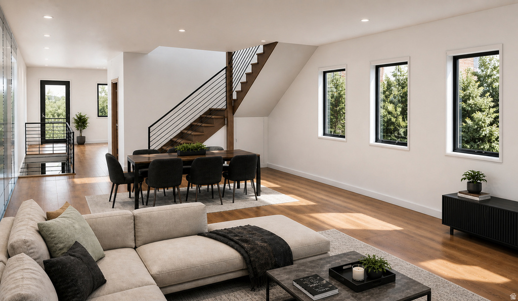 Open-concept living area featuring wood-finish flooring and recessed lighting