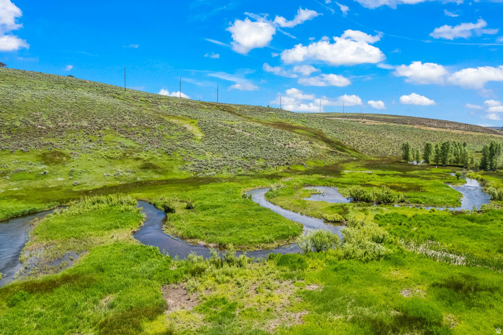 Natural landscape with a winding river, verdant grasslands, and distant hills