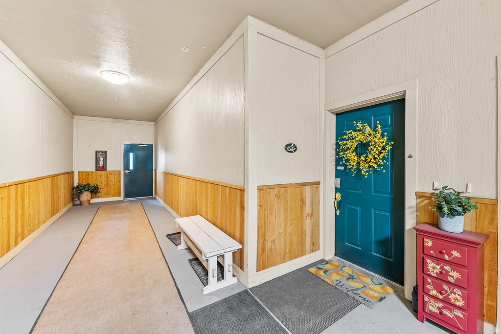 Entryway featuring wood paneling, light wall finishes, and a flush-mount ceiling light