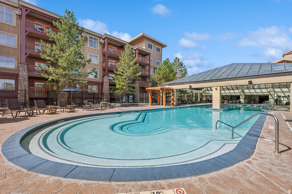 Outdoor swimming pool with integrated steps, surrounded by stamped concrete decking
