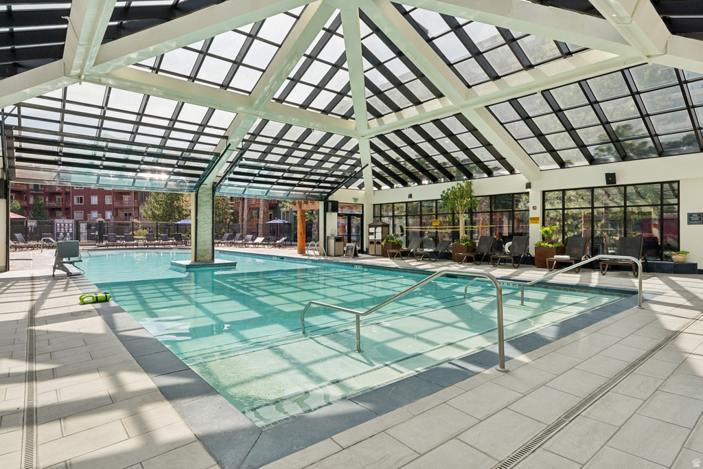 Indoor swimming pool with a skylight roof and expansive window walls