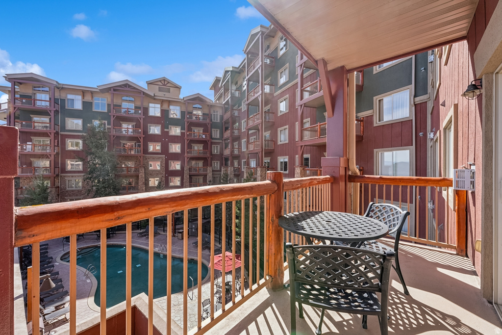 Private balcony featuring a wood railing and a concrete floor
