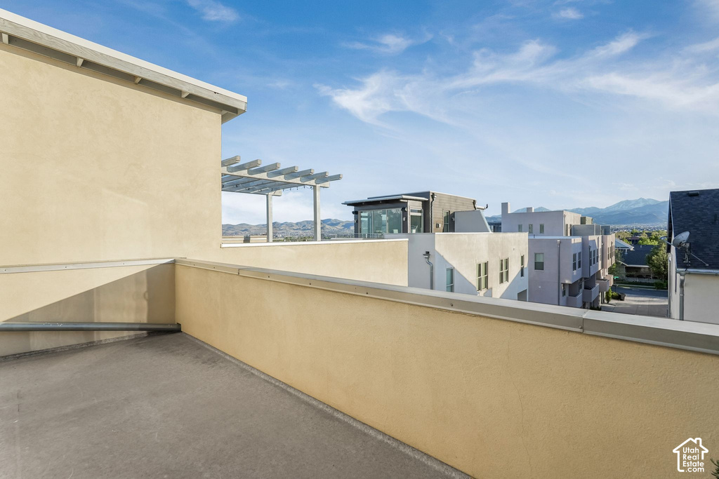 Rooftop patio with light-toned stucco walls and concrete flooring