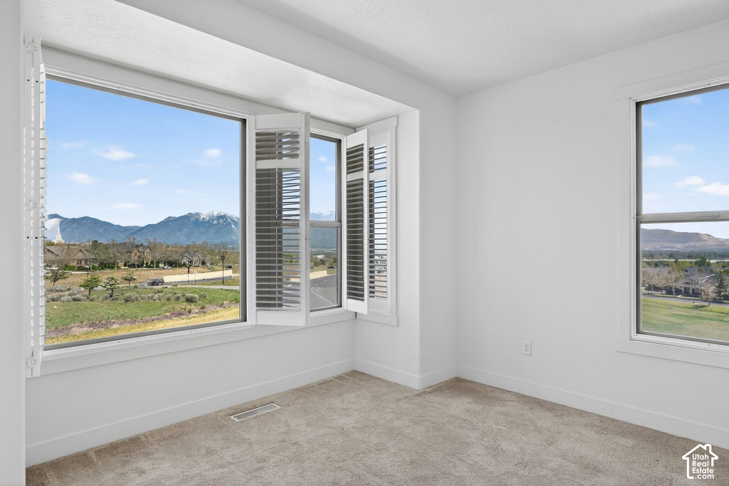 Expansive window offering distant mountain scenery