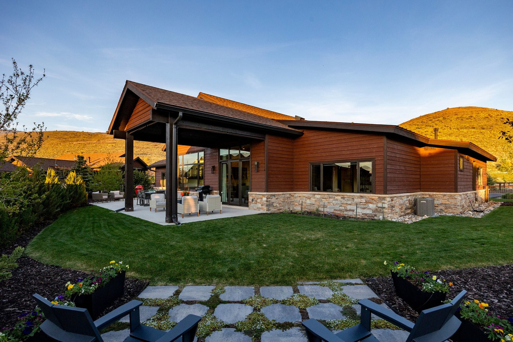 Modern architectural design with a covered patio, extensive glass doors, and durable siding