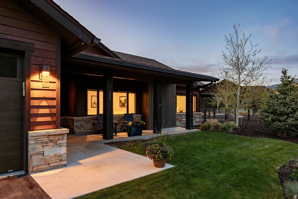 Modern exterior featuring dark wood siding and stacked stone accents