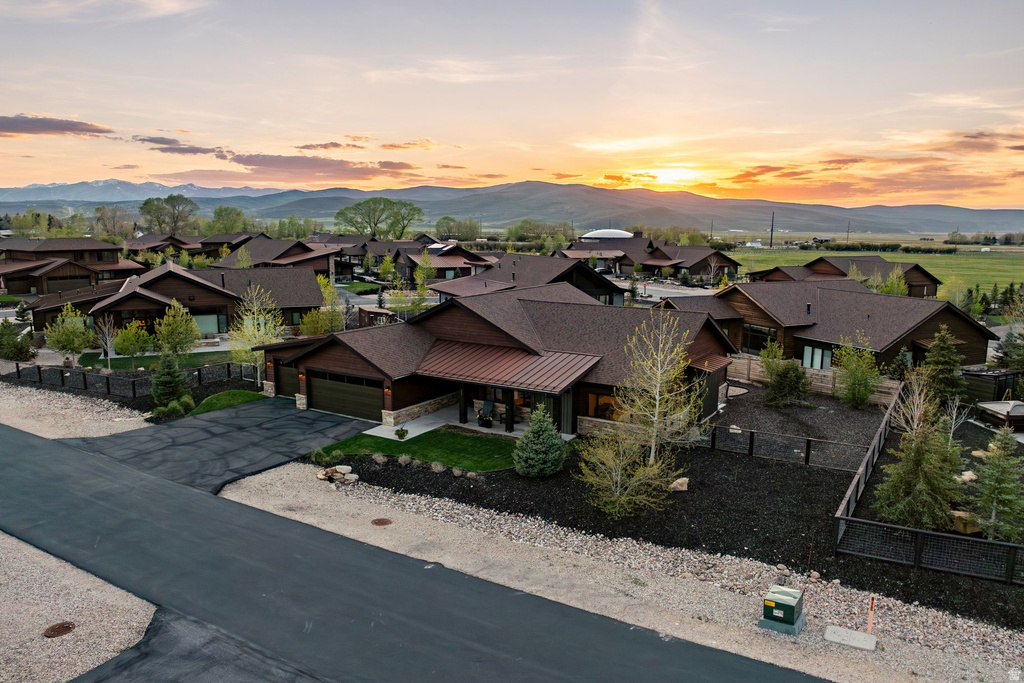 Contemporary residential community featuring dark wood-sided homes with brown shingle roofs