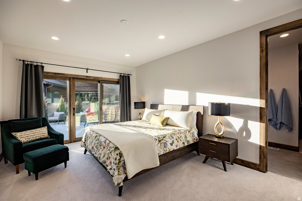 Recessed lighting illuminates this room, featuring light-toned carpeting and neutral wall paint