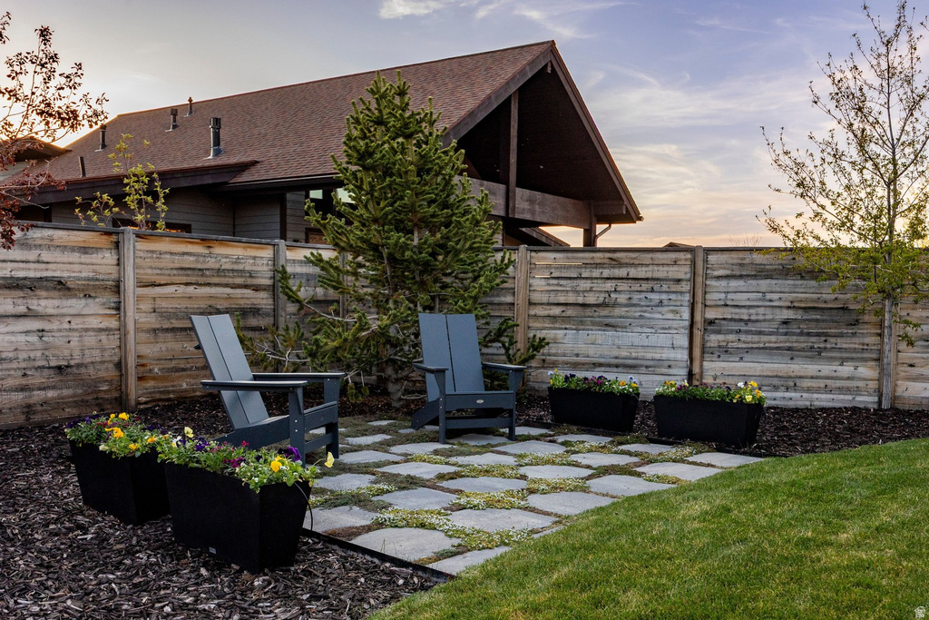 Outdoor patio area featuring square paver stones with interspersed ground cover