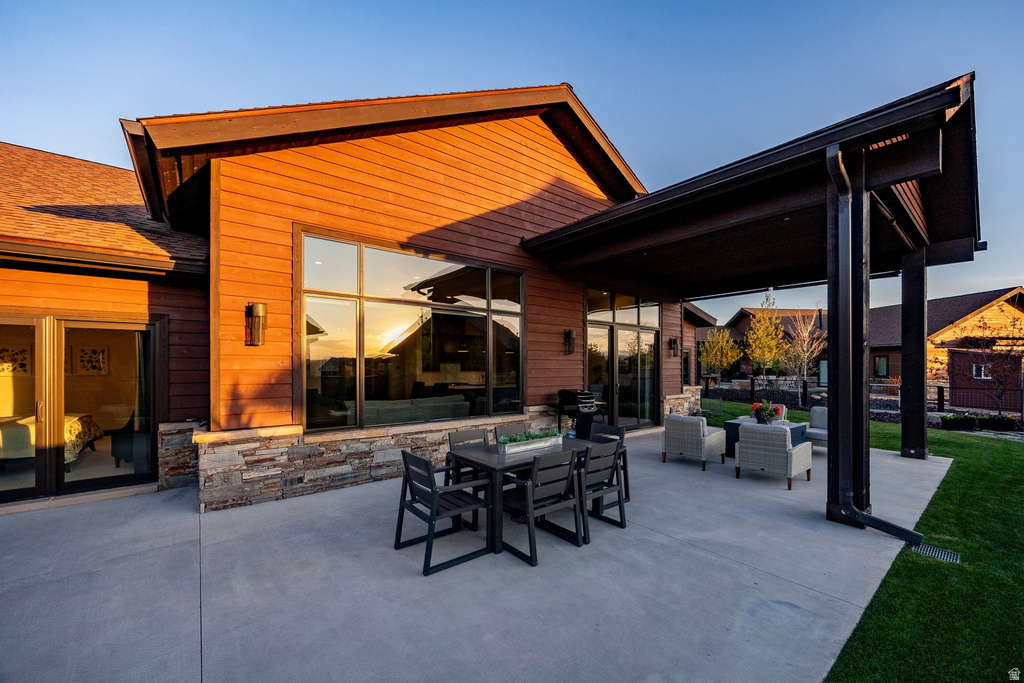 Expansive concrete patio offering a covered outdoor living area and an additional uncovered section