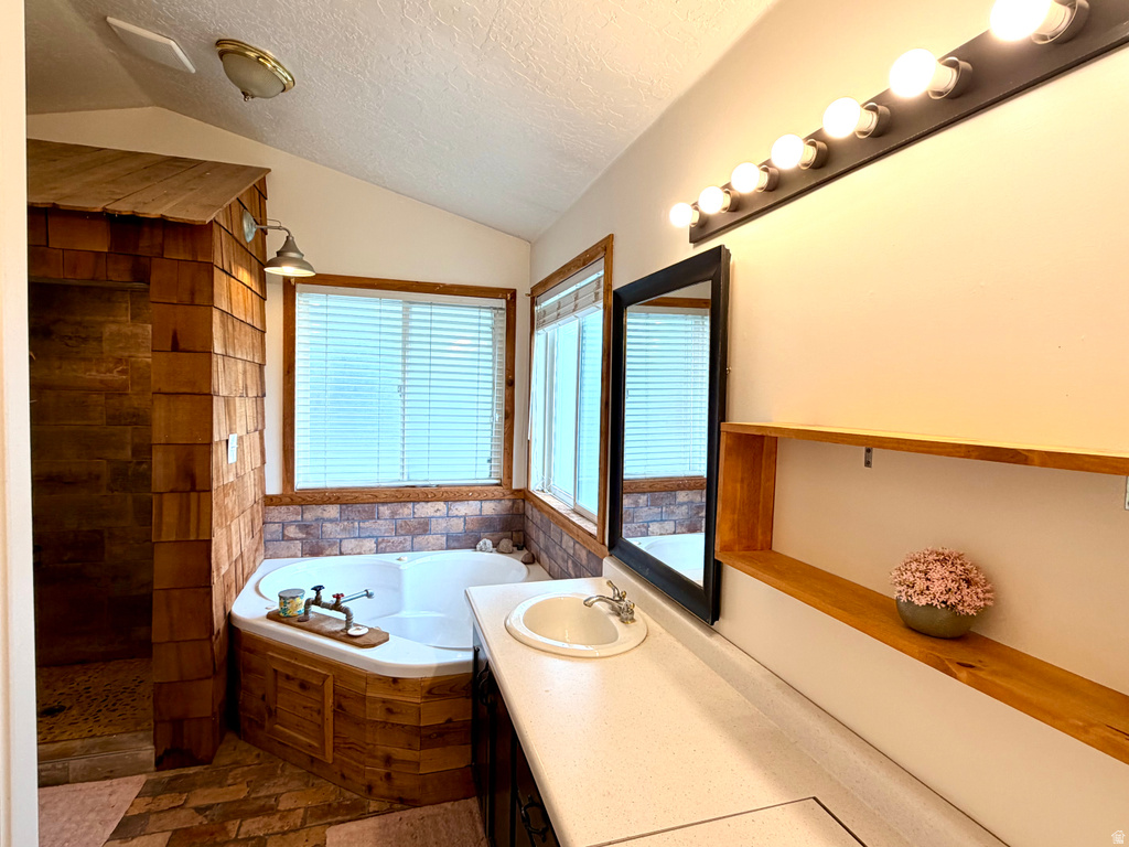 Bathroom featuring a corner soaking tub with wood-finish paneling, an adjacent walk-in shower with wood-finish shiplap siding, and large windows with blinds