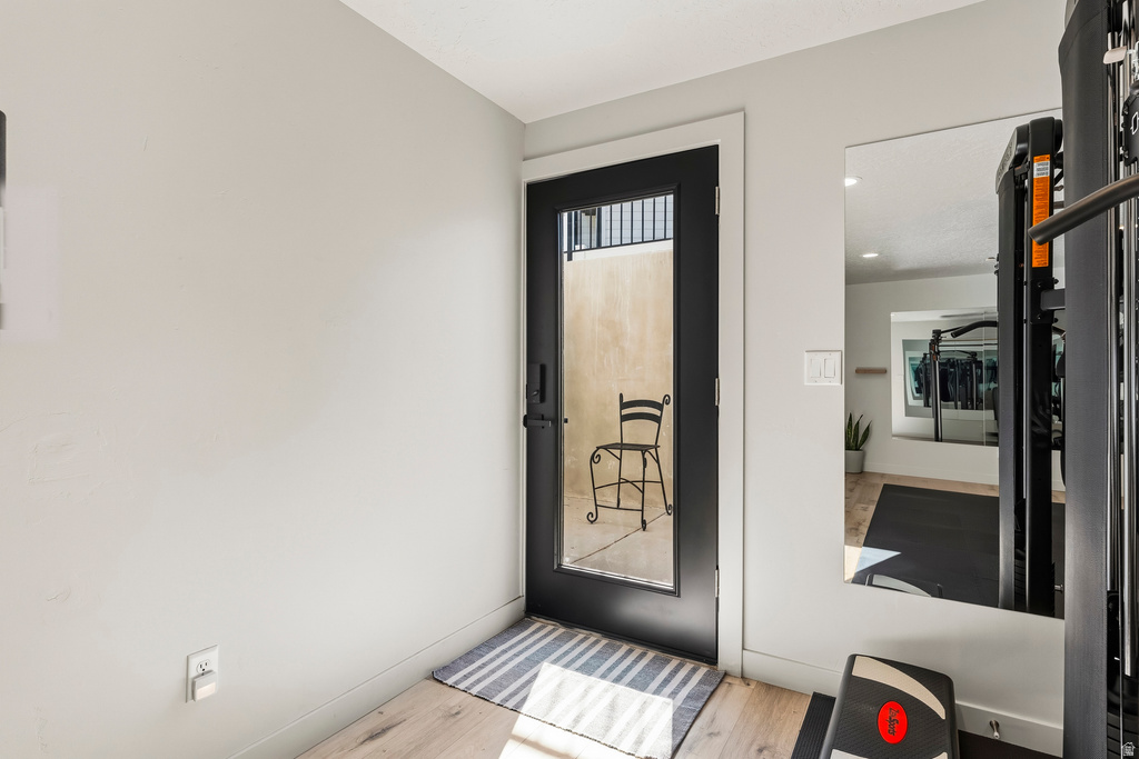 Full-light glass door with black frame and hardware