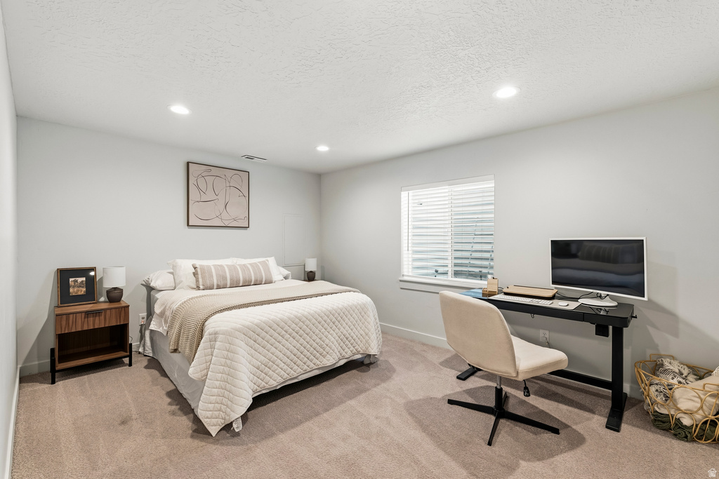 Carpeted bedroom featuring recessed lighting, a window with blinds, and white painted walls
