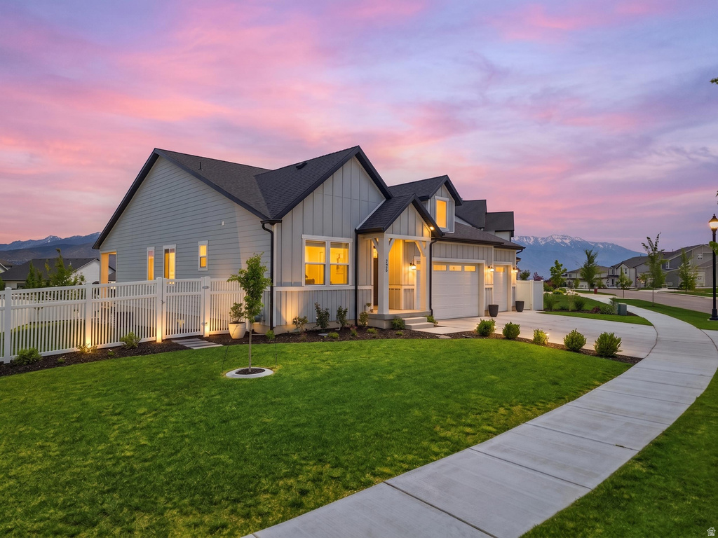 Contemporary residence featuring light gray siding with white trim accents and a dark roof