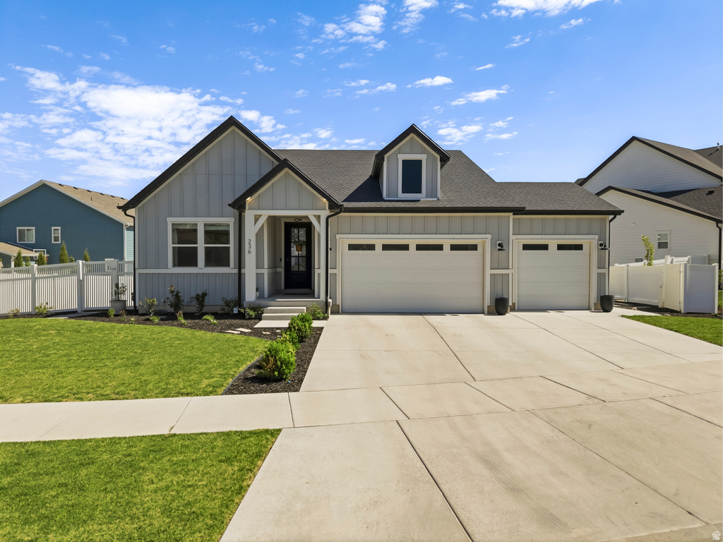 Contemporary farmhouse-style exterior featuring light gray board and batten siding