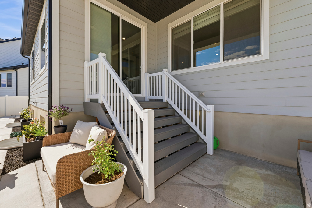 Exterior patio with composite decking stairs and white railings