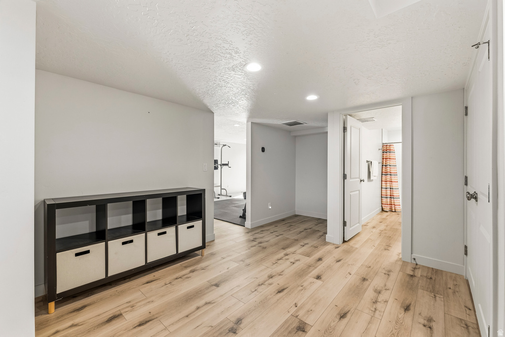 Bright interior space featuring light wood-finish flooring and recessed lighting