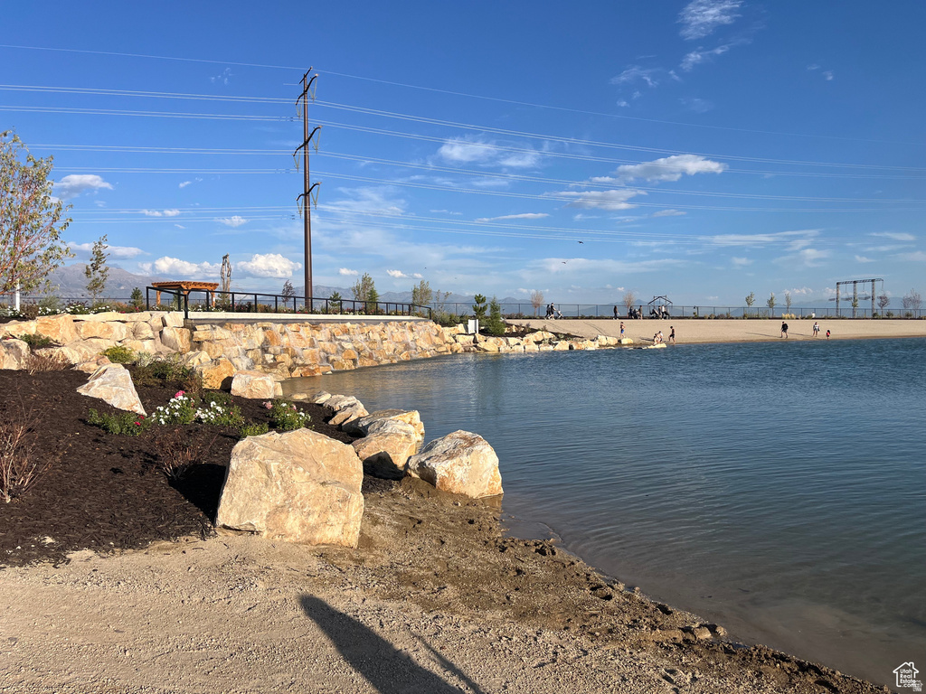 Water feature with a sandy shore and rock-lined edge