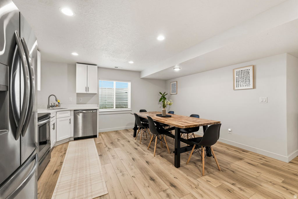 Open-concept living space with light wood-finish flooring
