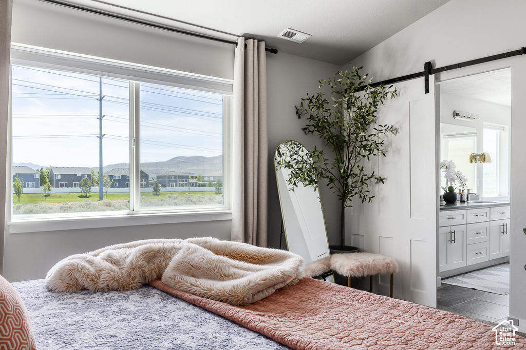 Bright interior space featuring a large window, white trim, and light-colored walls
