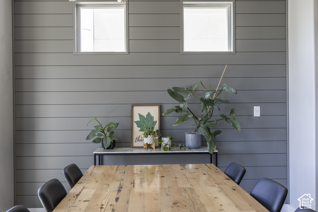 Accent wall featuring horizontal shiplap paneling and two square windows