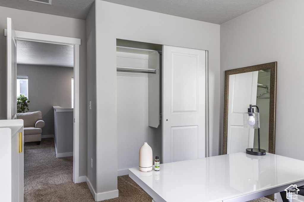 Interior room with neutral wall color and carpet flooring