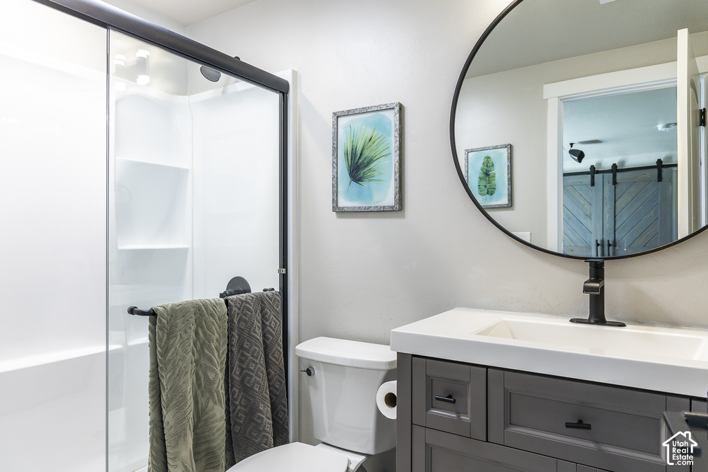 Modern bathroom featuring a single-basin vanity with a white countertop and gray cabinetry