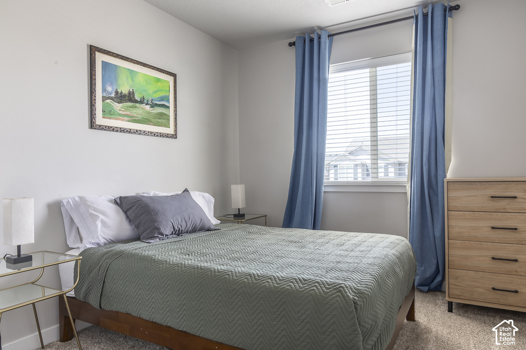 Bedroom featuring light-colored walls and carpeted flooring