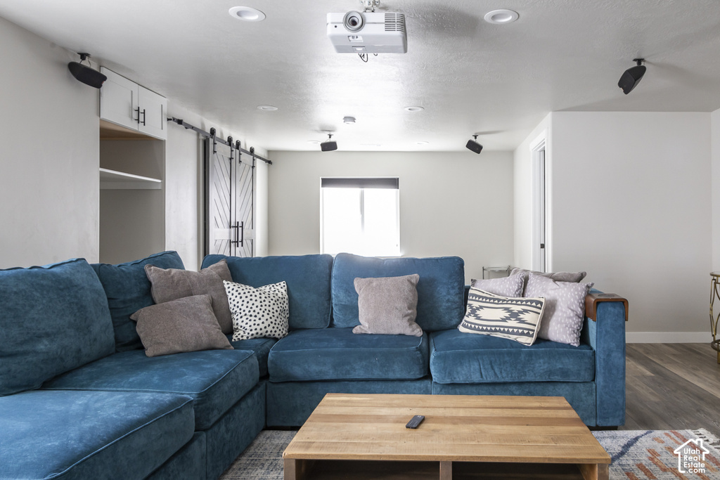 Entertainment area featuring ceiling-mounted projection equipment and recessed lighting