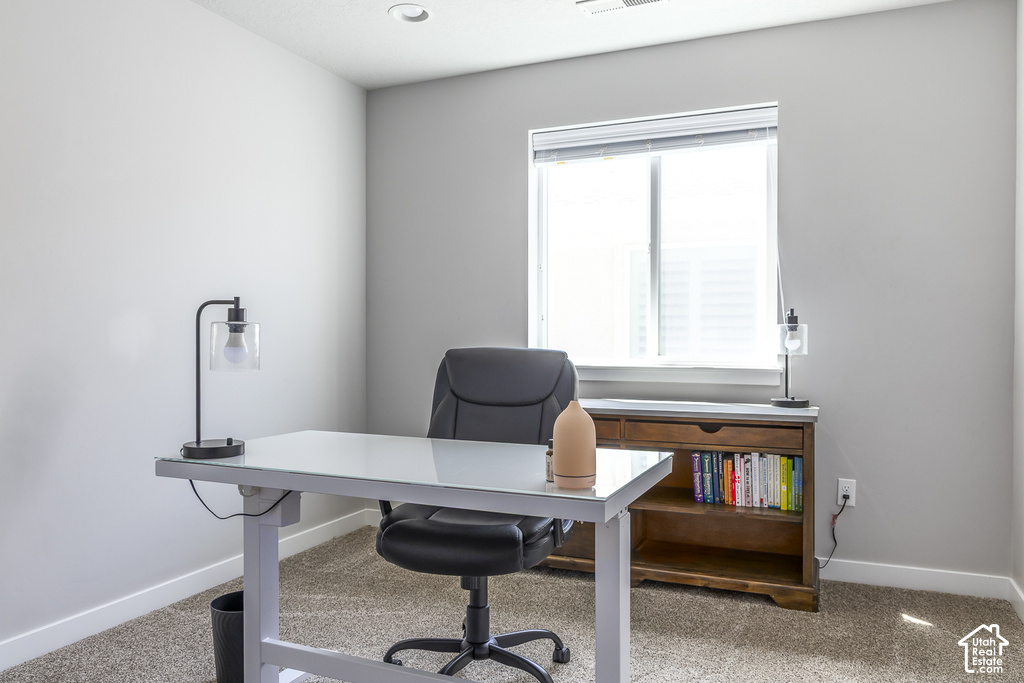 Room featuring a window with blinds, recessed ceiling lighting, and neutral-toned carpet flooring